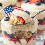 A serving of the layered 4th of July Trifle in a glass cup.