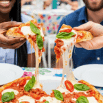 Two hands holding fresh slices of the finished Bruschetta Pizza.