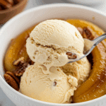 A spoonful of creamy Buttermilk-Pecan Ice Cream with a candied pecan.