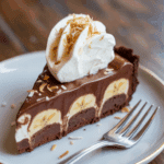 A perfect slice of the finished Chocolate-Banana Ice Cream Pie on a plate.