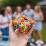 A hand holding a festive Fireworks Blondie at a 4th of July party.