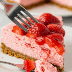 A perfect slice of Frozen Strawberry Cheesecake ready to be eaten.