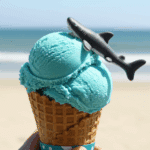 A scoop of No-Churn Shark Ice Cream on a cone, garnished with a gummy shark.