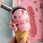 Scooping a perfect scoop of the finished Strawberry-Soda Ice Cream into a cone.