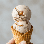Two scoops of homemade Sweet-and-Salty Ice Cream in a waffle cone.