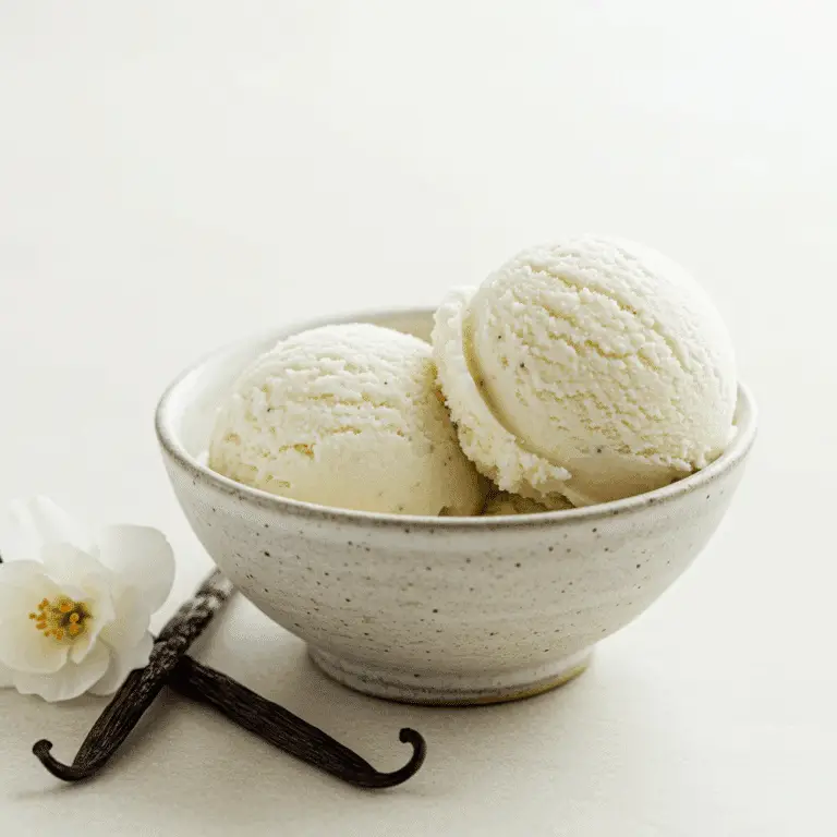 A bowl with two scoops of creamy, homemade Vegan Vanilla Ice Cream.