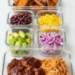 Meal prep containers with the separate components for the BBQ Chicken Sweet Potato Bowl.