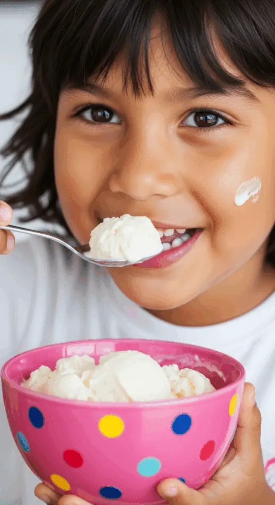 A happy child eating a bowl of homemade Cottage Cheese Ice Cream.