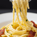 A forkful of the finished, ultra-creamy Spaghetti Carbonara.