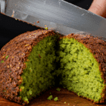 A Falafel Burger cut in half to show the fluffy green interior.
