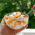 A person enjoying a refreshing bowl of Peaches and Cream on a sunny summer day.
