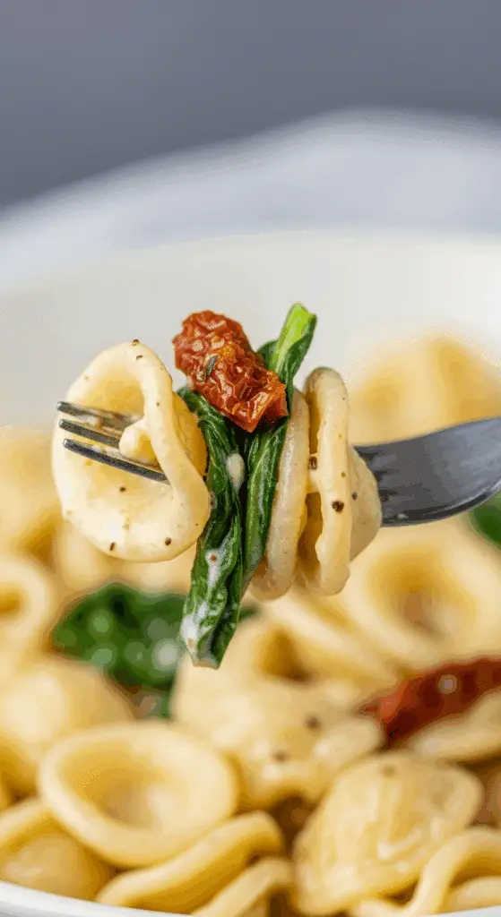 A forkful of the finished, creamy Goat Cheese Pasta.