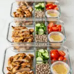 Meal prep containers with the separate components for the Greek Chicken Bowl.