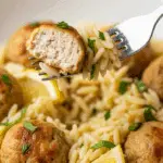 A forkful of the finished Greek Chicken Meatballs and Lemon Orzo.