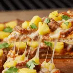 A slice of the delicious Grilled Flatbread with Pork and Pineapple being served.