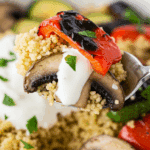 A spoonful of the finished Grilled Vegetable Bowl with yogurt sauce.