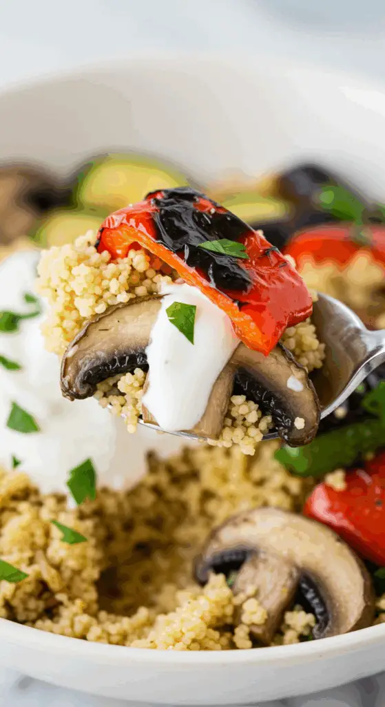 A spoonful of the finished Grilled Vegetable Bowl with yogurt sauce.