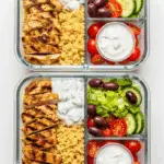 Meal prep containers with the separate components for the Instant Pot Greek Chicken Bowls.