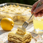 An elegant slice of Limoncello Tiramisu being served at a sunny, outdoor dinner party.