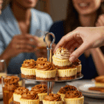 A hand taking a beautiful Mini Biscoff Cheesecake from a dessert platter at a party.