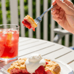 A person enjoying a Quick Strawberry Shortcake on a sunny summer day.