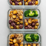 Four meal prep containers filled with the Roasted Vegetable Grain Bowl.