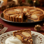 An elegant slice of homemade Pear-Walnut Chocolate Tart being served with a quenelle of mascarpone at a holiday dinner.
