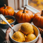 A person in a cozy sweater enjoying a bowl of homemade Healthy Pumpkin Ice Cream.
