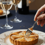 An elegant, individual Quick Pear Tart being served on a plate at a sophisticated dinner party.
