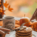 A person enjoying a delicious and healthy breakfast of Apple Pie Protein Pancakes on a cozy fall morning.