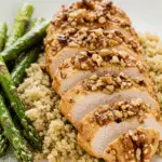 A beautiful plate of homemade Walnut-Crusted Chicken, served over a bed of fluffy quinoa for a healthy meal.