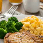 A fun, kid-friendly dinner plate with a homemade, crispy Ranch Pork Chop, served with mac and cheese and broccoli.