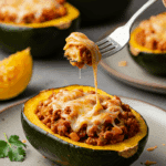 A single, perfect, homemade Enchilada Stuffed Acorn Squash on a dinner plate, being served for a family dinner.