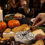 The finished, abundant, and spooky Halloween Charcuterie Board being enjoyed at a fun and sophisticated Halloween party.