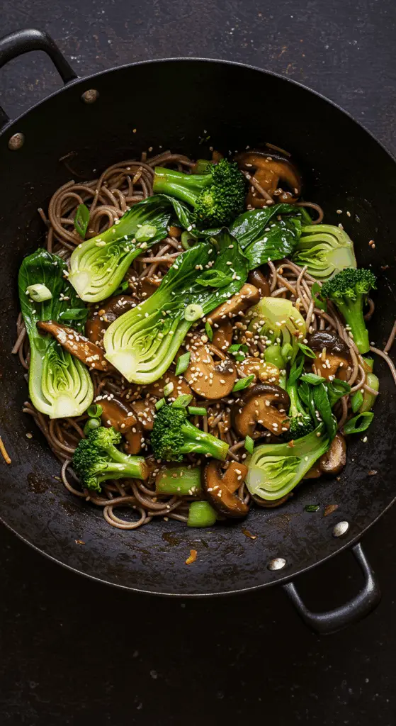 A beautiful, rustic wok of homemade, healthy Bok Choy Stir Fry with soba noodles, shiitake mushrooms, and a glossy sauce.