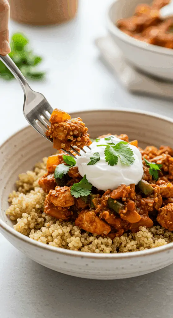 A beautiful bowl of homemade, healthy Mediterranean Turkey Skillet being served over a bed of quinoa for a delicious weeknight dinner.