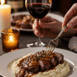 An elegant plate of homemade, restaurant-style Steak Marsala being served at a sophisticated dinner party.