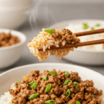 A cozy bowl of homemade, flavorful Garlicky Ginger Ground Beef being enjoyed with chopsticks for a casual family dinner.