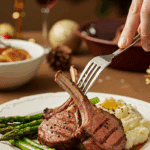 A beautiful plate of a homemade, elegant, and glossy Broiled Lamb Chops, being served with creamy mashed potatoes and roasted asparagus at a holiday dinner.
