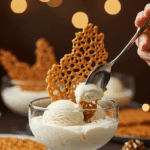A beautiful, lacy, and curved "Grandma's" Lace Cookie being served as a "tuile" garnish on a glass dish of vanilla bean ice cream at a holiday party.